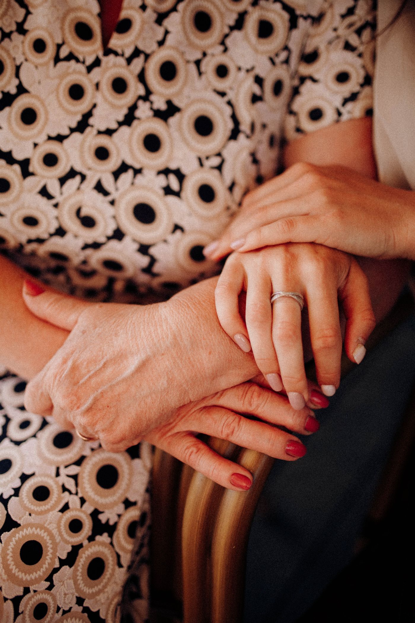 Adult daughter holding her elderly mother's hands